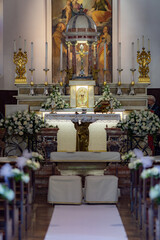 Fototapeta na wymiar front view of an altar of a catholic church decorated for a wedding