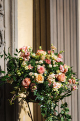 Wedding floral arrangement with pink and yellow  roses.