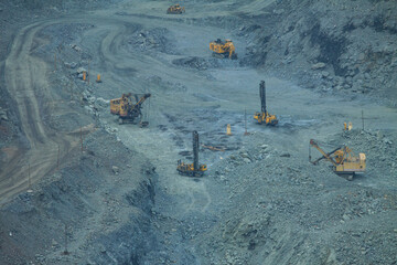The process of iron ore mining in an open pit. Operation of drilling rigs in a quarry for the...