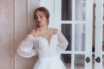 Portrait of beautiful young bride in the airy wedding dress. Wedding make-up. Natural beauty.