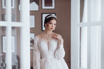 Portrait of beautiful young bride in the airy wedding dress. Wedding make-up. Natural beauty.