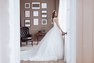 Fototapeta premium Portrait of beautiful young bride in the airy wedding dress. Wedding make-up. Natural beauty.