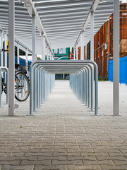 A lot of bike parking places with metal pipes looks like tunnel