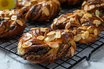 Buns with poppy seeds from yeast dough, decorated with almonds.