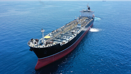 Aerial drone photo of crude oil tanker carrier anchored in deep blue open ocean sea
