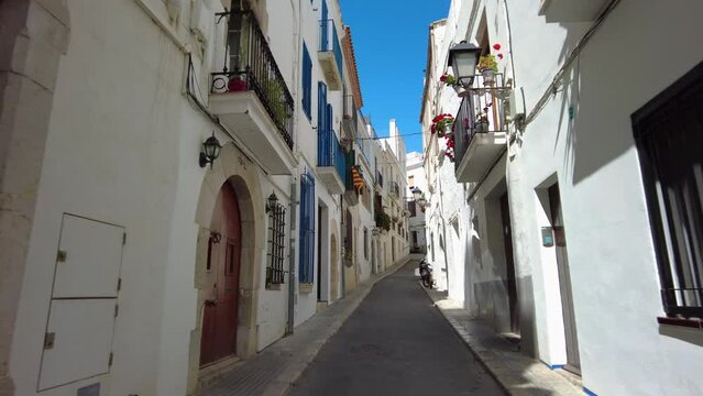 Walking on a narrow street in Sitges, Costa Dorada in Catalonia, spain