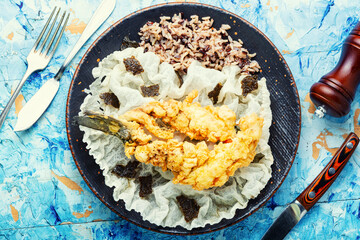 Fried sea bass with wild rice.