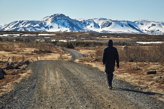 Man walking on gravel road in Iceland