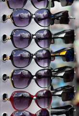 Many sunglasses on display for sale