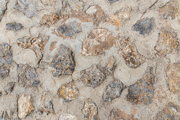 a photo of an ancient stonework covered with cement mortar