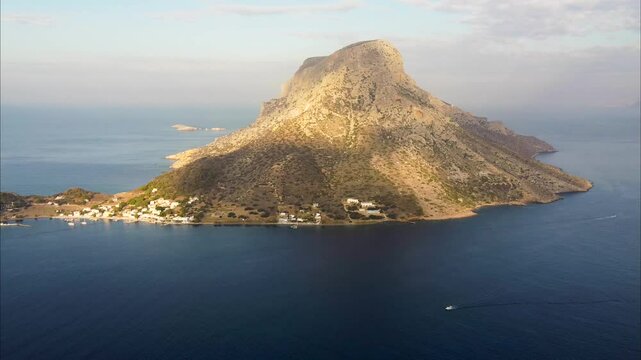 Push in aerial shot of Telendos island on sunny morning. Aegean Sea, Greece.