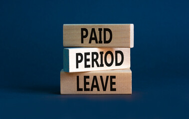 Paid period leave symbol. Concept words Paid period leave on wooden blocks. Beautiful grey table grey background. Business medical paid period leave concept. Copy space.