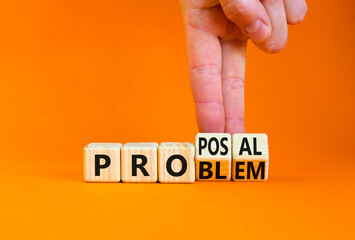 Solving a problem and making proposal symbol. Businessman turns wooden cubes and changes the word Problem to Proposal. Beautiful orange background. Business problem to proposal concept. Copy space. - obrazy, fototapety, plakaty