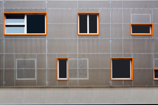 facade gray metal construction with orange-framed windows