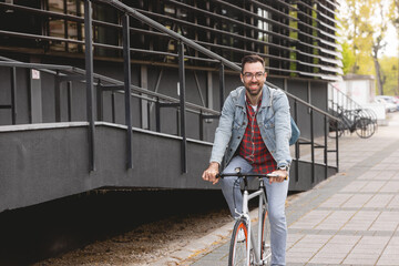Fototapeta premium Young man riding a bicycle
