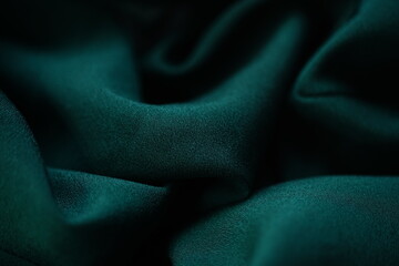 Delicate dark green fabric, emerald material chiffon waves