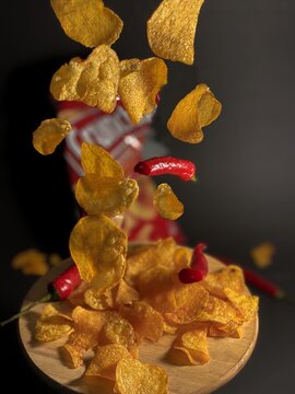 Chips with red pepper in the dark background