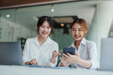financial, Planning, Marketing and Accounting, portrait of Asian woman Economist using calculator to calculate investment documents with partners on profit taking to compete with other companies