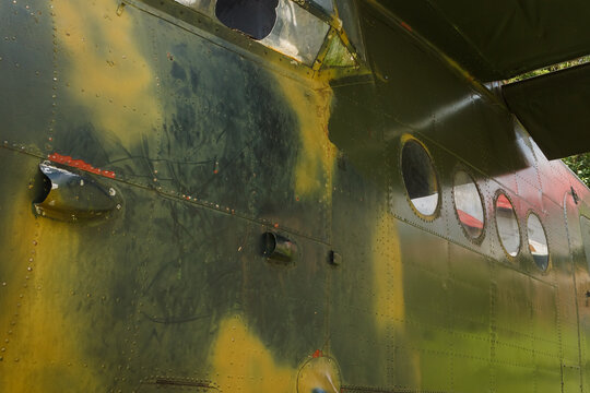 Details of the fuselage of an old aircraft. Old camouflage surface on a military aircraft 