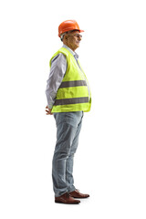 Full length profile shot of a mature male engineer with a safety vest and helmet