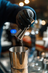 Fototapeta na wymiar bartender's male hands making a cocktail