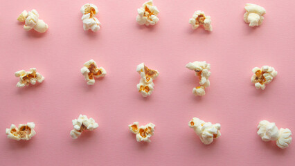 Popcorn arranged in order with a pattern on light pink background