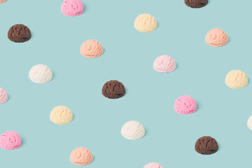 Ice cream various flavor scoops pattern on a pastel blue background. Summer, refreshment minimal concept.