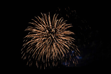 Firework over the ordinary European city at night near water, orange © ALEXANDR YURTCHENKO