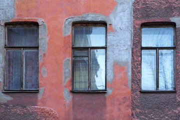 Wall old building. Narrow windows, peeling paint