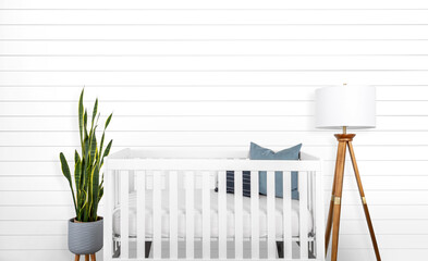 A modern farmhouse styled baby nursery with a blank shiplap wall.