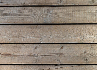Old wooden wall made of rough uncolored boards. Background photo texture
