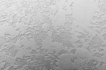 White wall with decorative plaster, frontal view. Abstract background photo