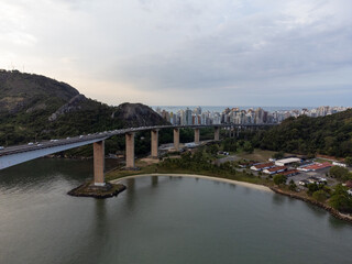 Amazing coastal city one of the capitals of Brazil Vitoria with long bridge over the canal - aerial drone view