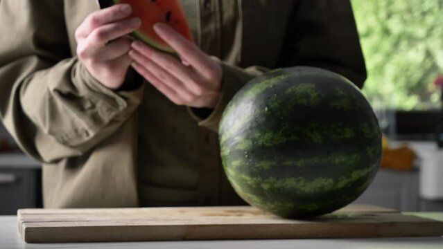 Man cut watermelon on desk on kitchen