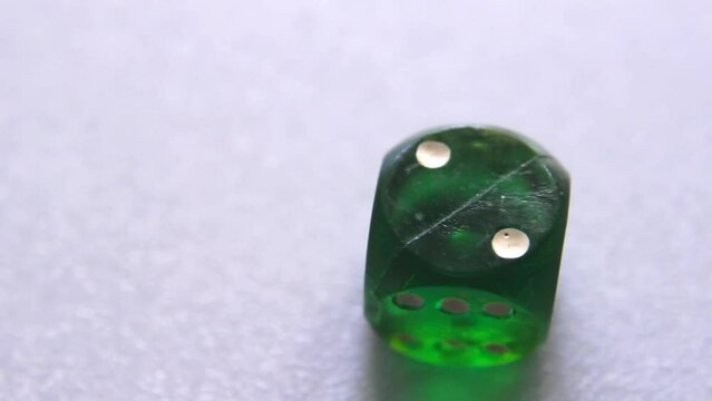 Testing probability in gamble entertaining. Craps dice close up showing number two on cube front side
