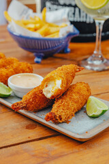 Colorful Food Beach Appetizer Starts Snacks Fresh Delicious Menu Recipe Meal Meat Chicken Fries Fish Seafood Beer on a wooden table