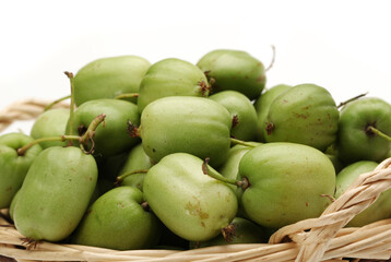 mini kiwi baby fruit (actinidia arguta) on white background 