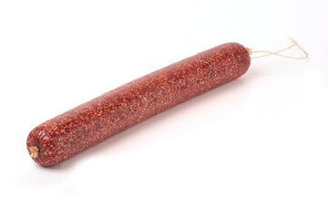 Beef Dried Smoked Salami sausage in close-up, isolated on a white background.