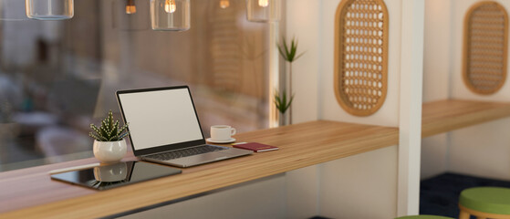 Minimal Scandinavian coffee shop interior design with laptop and tablet mockup on table.