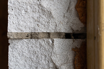 The gap between the window and the wall is filled with mounting foam, close-up. Aerated concrete...