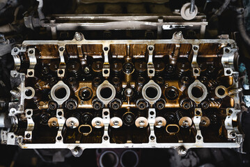 Disassembled car engine in oil. Cylinder head of an automobile engine. Inside the car being...