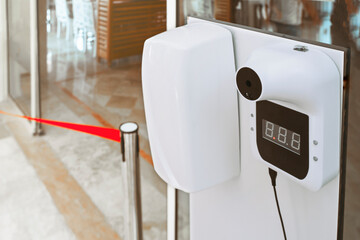 Digital thermometer, infrared scanner in front of the entrance. Electronic body temperature...