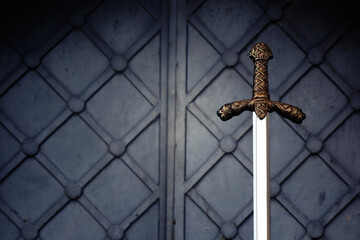 photo of knight sword over dark background. Medieval period concept