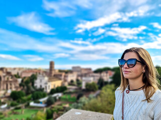 Tourist woman with panoramic view on ancient ruins of Roman Forum. Skyline from Palatine Hill in city of Rome, Lazio, Italy, Europe, EU. Temple Antoninus Faustina, Saturn, Victor Emmanuel II monument