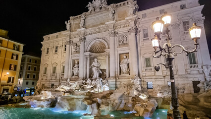 Illuminated Trevi Fountain at night. Largest Baroque fountain in the city. Famous fountain in the...
