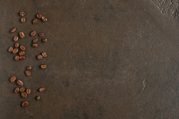 Fototapeta na wymiar Coffee beans, flat lay. Top view. Brown background, copy space