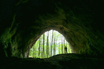 Interior view of man standing at the entrance of the Drachenhoehle (Dragon Cave) in Pernegg an der Mur in Styria, Austria. Cave near mount Rothelstein in Mixnitz in the Grazer Bergland. Grotto, Europe
