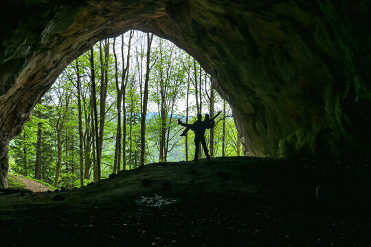 Interior view of man holding woman at the entrance of the Drachenhoehle (Dragon Cave) in Pernegg an der Mur in Styria, Austria. Cave near Rothelstein in Mixnitz in the Grazer Bergland.Grotto