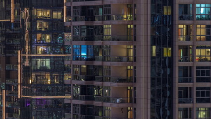 Windows of apartment buildings at night timelapse, the light from the windows of houses