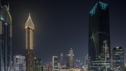 Dubai International Financial district aerial night timelapse. Panoramic view of business and financial office towers.